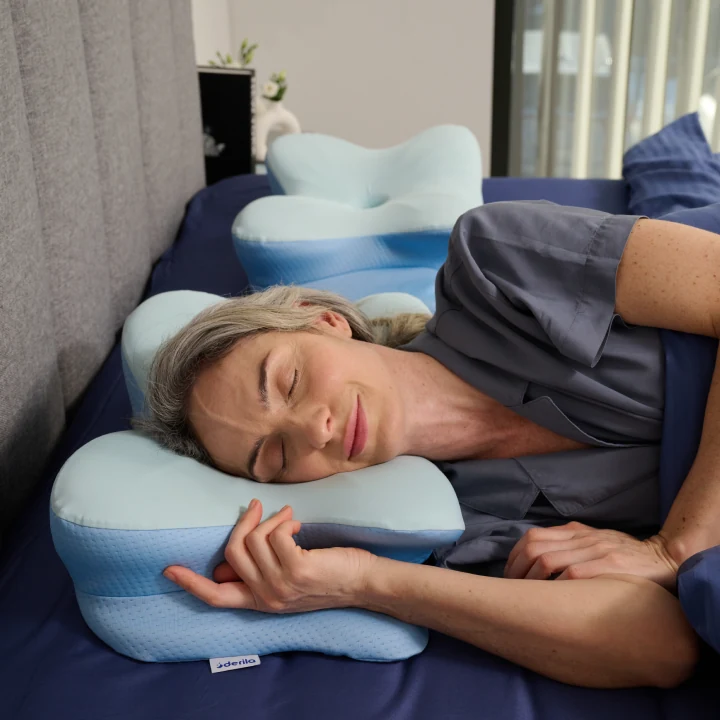 Side sleeper using a Derila contoured pillow with brand tag visible