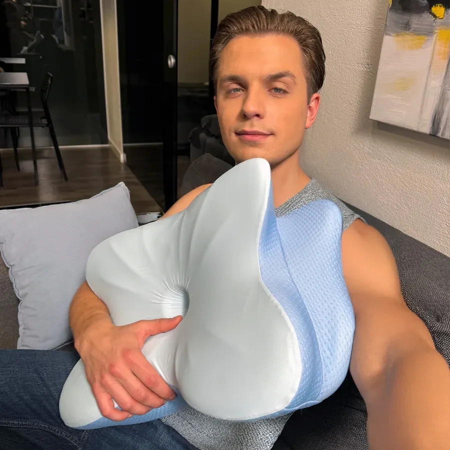 Person holding the Derila ERGO butterfly-contour pillow