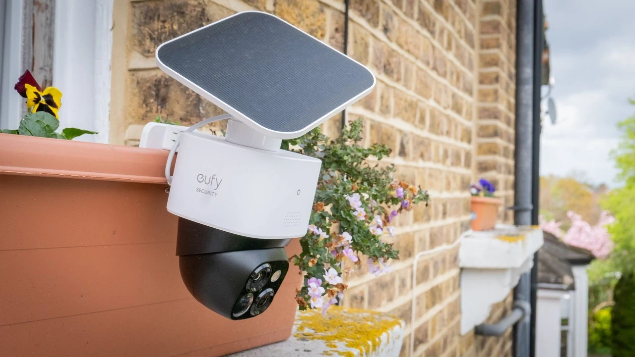 eufy Security solar camera clipped to a planter box outside a window