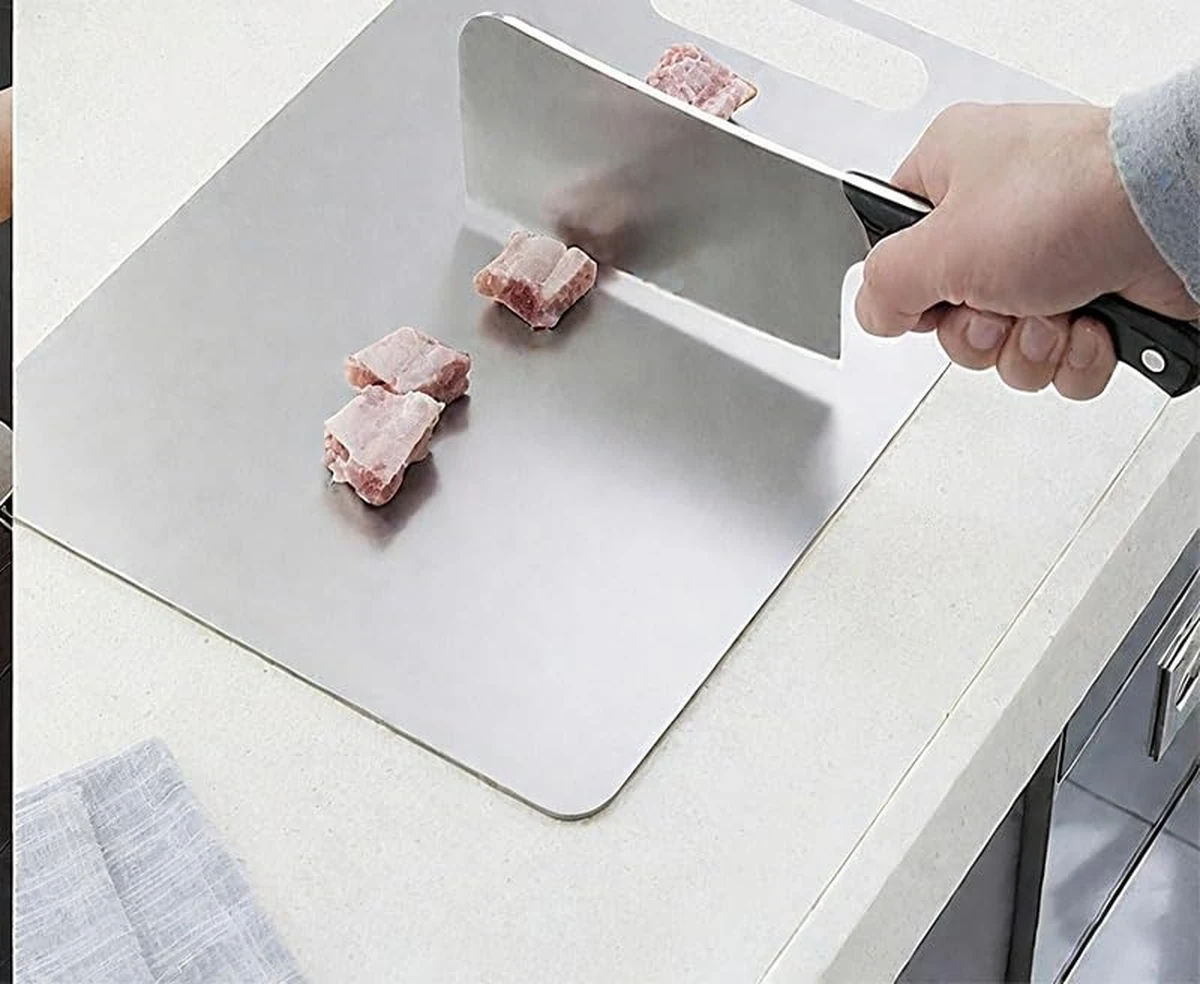 Chopping meat with a cleaver on a Katori titanium cutting board