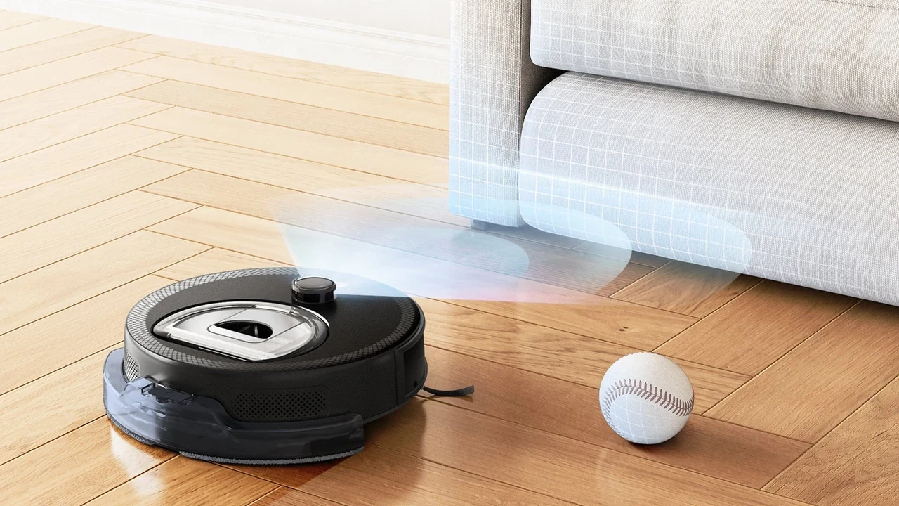 Black Lefant robot vacuum with LiDAR turret detecting a baseball on wood floor