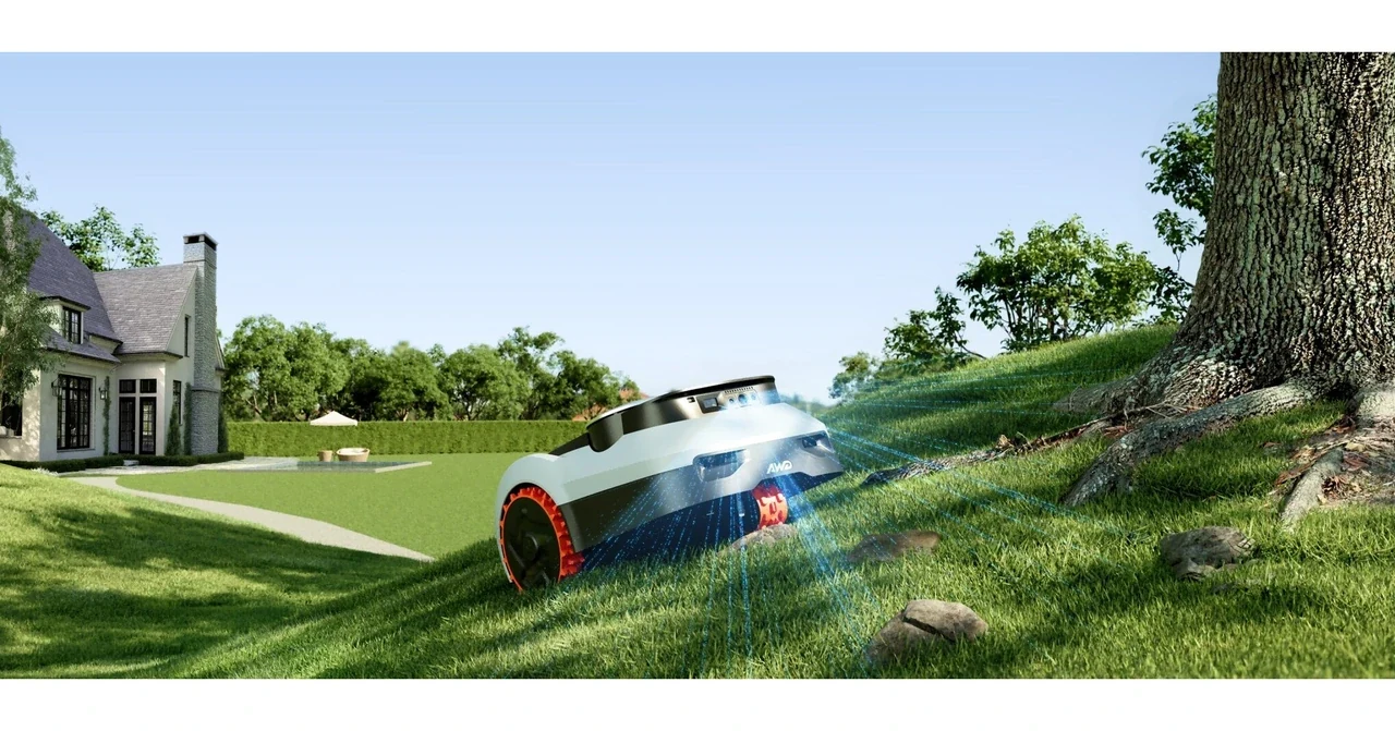 Navimow AWD robot mower climbing a steep grassy slope near a tree