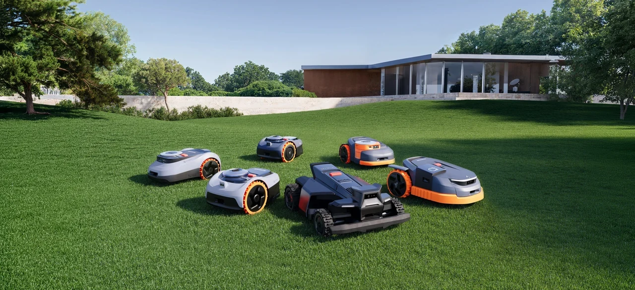 Multiple Segway Navimow robot mower models lined up on a sloping lawn