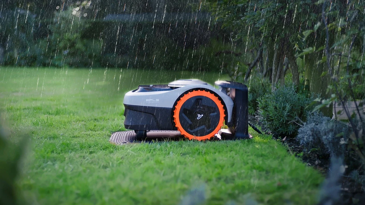 Navimow robot mower at its charging station in the rain