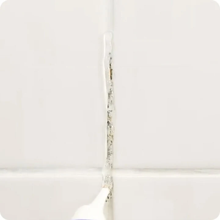 Close-up of NuroClean gel applied into a moldy tile grout line