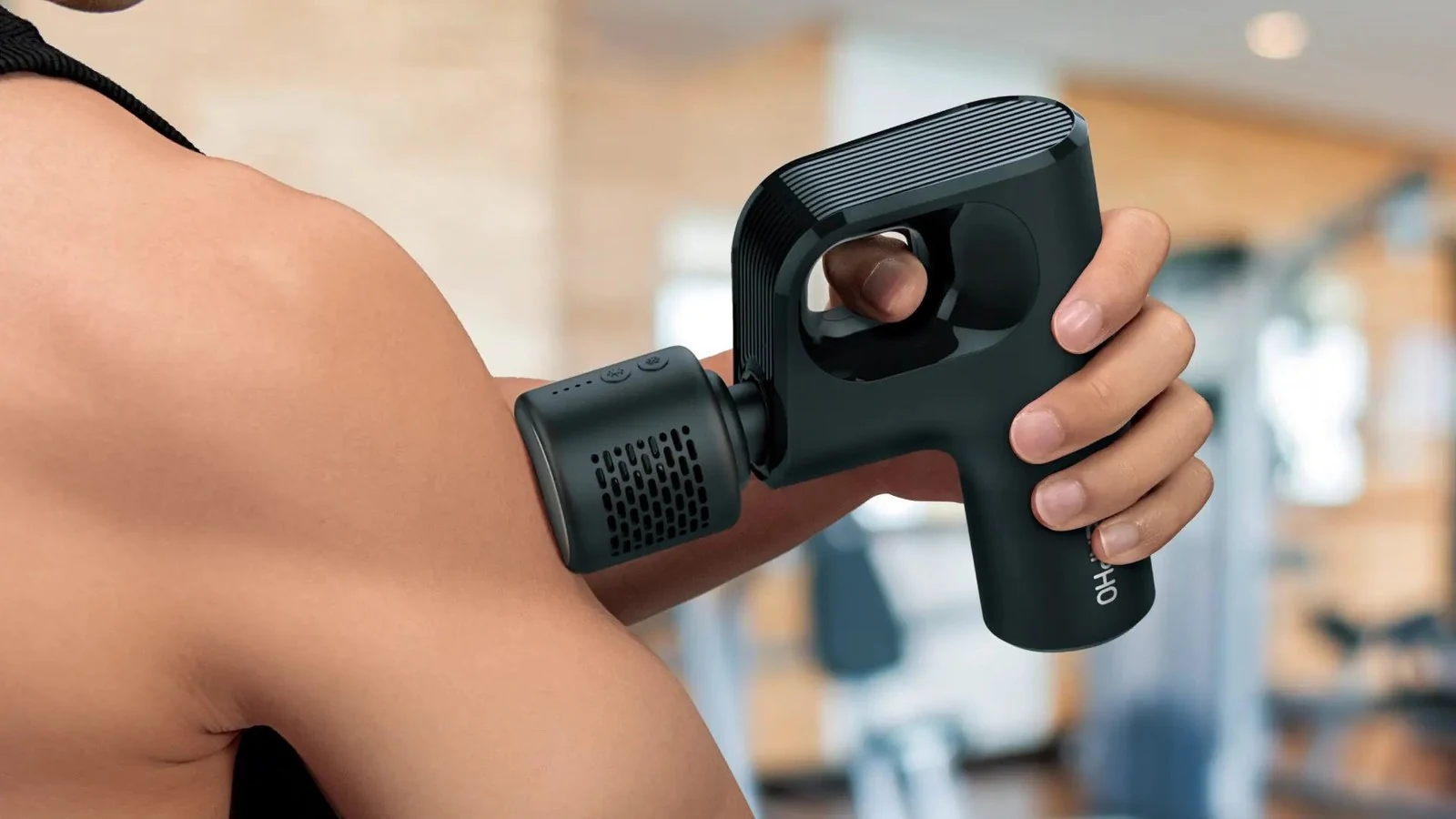 RENPHO massage gun with ergonomic handle used on the upper arm