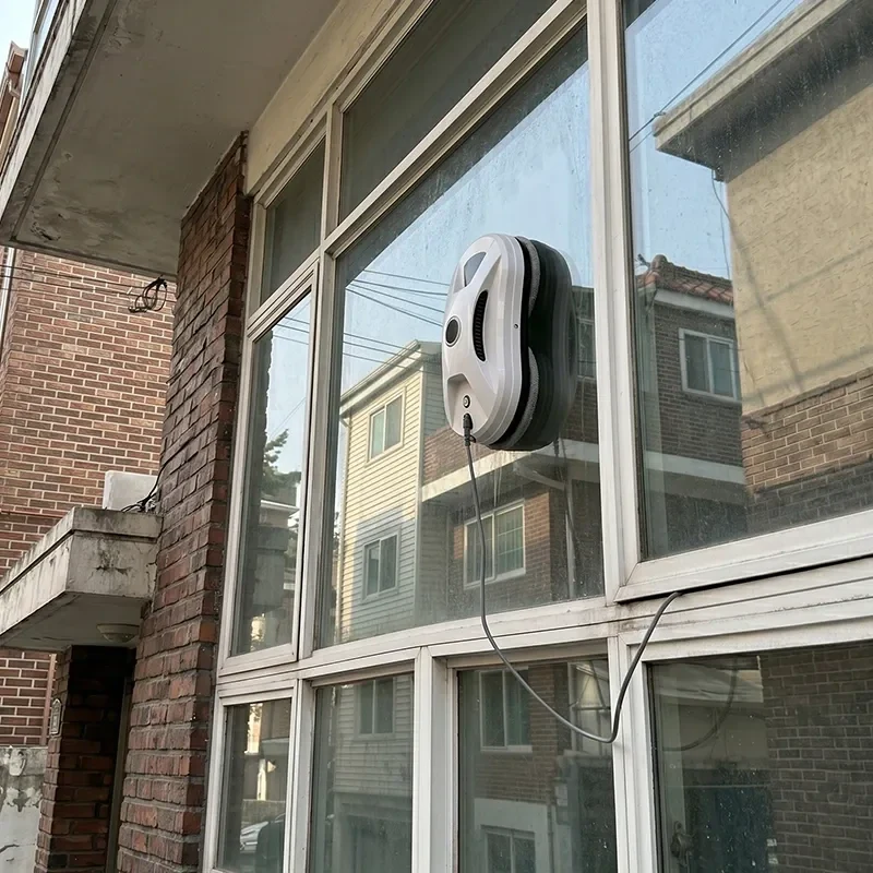 Whirlclean robotic window cleaner on a multi-pane brick building window