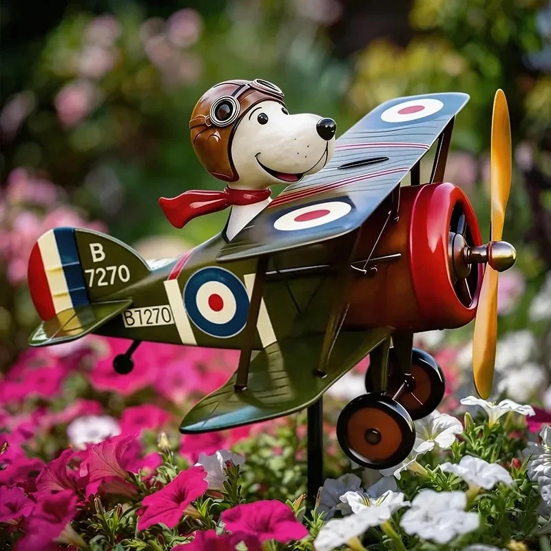 Windodream Sky Dreamer biplane garden spinner among pink and white petunias